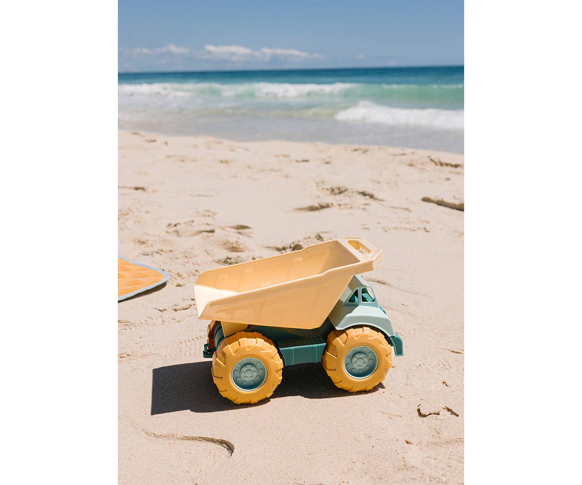 Camion Benne Vert Monnëka avec benne basculante et roues mobiles pour enfants dès 6 mois, idéal pour jouer dans le sable et à la plage.